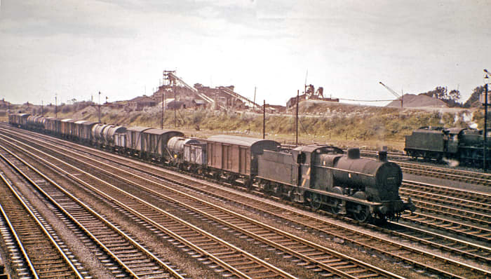 Goods... often overlooked, under-represented on layouts with expresses whizzing past The humble 0-6-0 and its workload. An ex-Midland Railway 0-6-0 mixed freight locomotive clanks past an industrial north-western backdrop with a lengthy trip-working