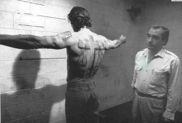 DeNiro's character, convict-out-for-revenge Max Cady, was covered in tattoos, many of which taken from Biblical imagery. Scales of justice were rendered as a cross-themed full-back tattoo with multiple Bible quote tattoos on the chest and arms.