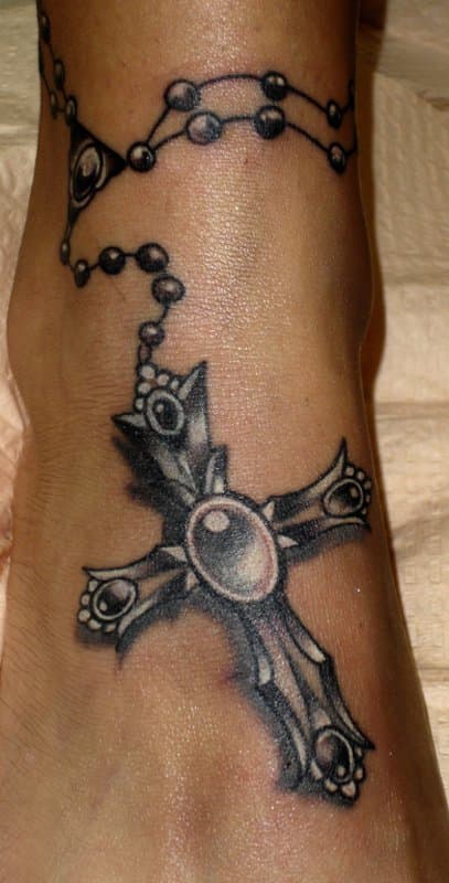 The lines, circles, and pointed edges all add to the Gothic look of this cross tattoo. I would consider this a well-crafted pure Gothic tattoo.