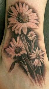 The artist behind this tattoo has creatively added depth to these daisies to enhance the overall impact of the design.