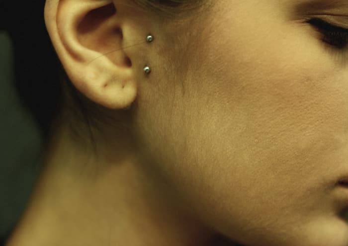 Most tragus piercings are cartilage piercings in which the jewelry goes through the cartilage in the tragus area of your ear. Vertical tragus piercings only go through the skin.