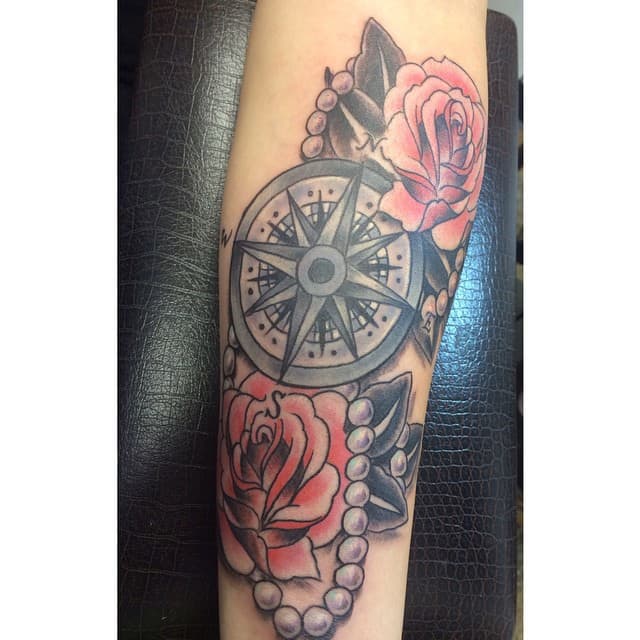 A classic idea for a tattoo with roses and a compass - this one is large enough for beautiful detail.