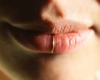 An alternative option to the traditional lip ring; placing the piercing in the center of the lip looks quite beautiful.