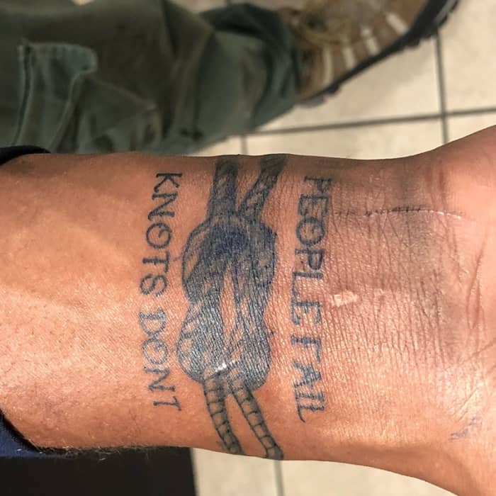 This one combines image with text very effectively in a bracelet tattoo.