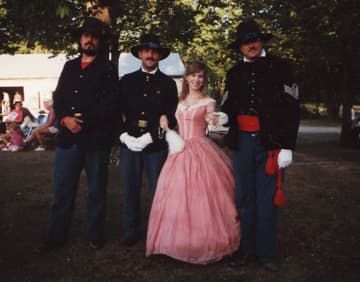 This was taken in Nova, OH, in July 1993. The first reenactment I ever attended in dress. The ballgown was bought at a theater sale for, I think, $15. With me are the gallant lads of the 7th Ohio Volunteer Infantry.