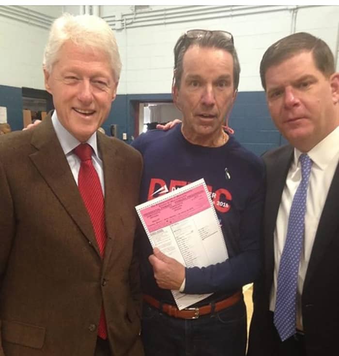 Bill Clinton posing with voter holding ballot inside West Roxbury polling station during voting hours on MA primary day.