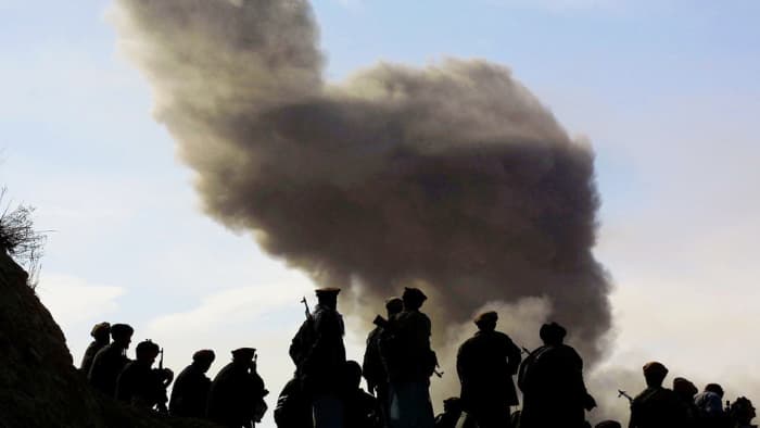 Northern Alliance soldiers, aligned with the U.S., watch as American warplanes drop bombs on the Taliban on Nov. 19, 2001, around the city of Kunduz, Afghanistan. The U.S. is still there over 15 years later trying to do the same thing.