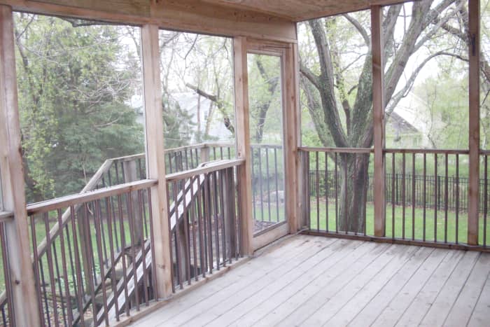 My beautiful cedar deck on a rainy fall day, unstained, clear-coated, and weathered to a nice gray after about two years. I clean the deck annually with dish soap, which usually takes part of an afternoon to sweep and scrub everything down.