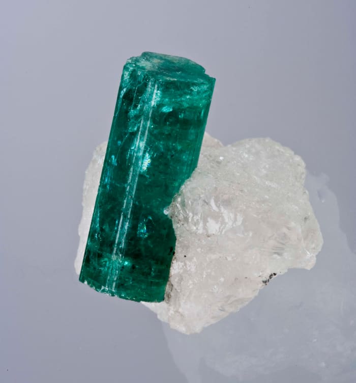 An emerald nestled into a knoll of quartz, as discovered in a Zambian mine.