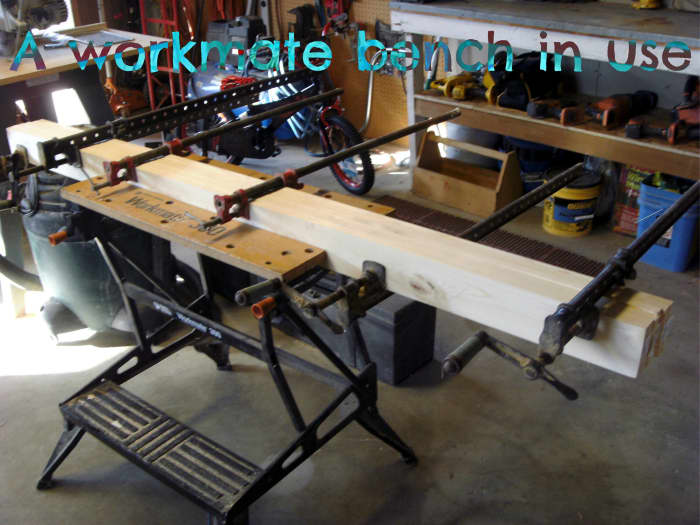 A workmate bench being used to hold a long beam as multiple large clamps were placed. Much better than the floor!