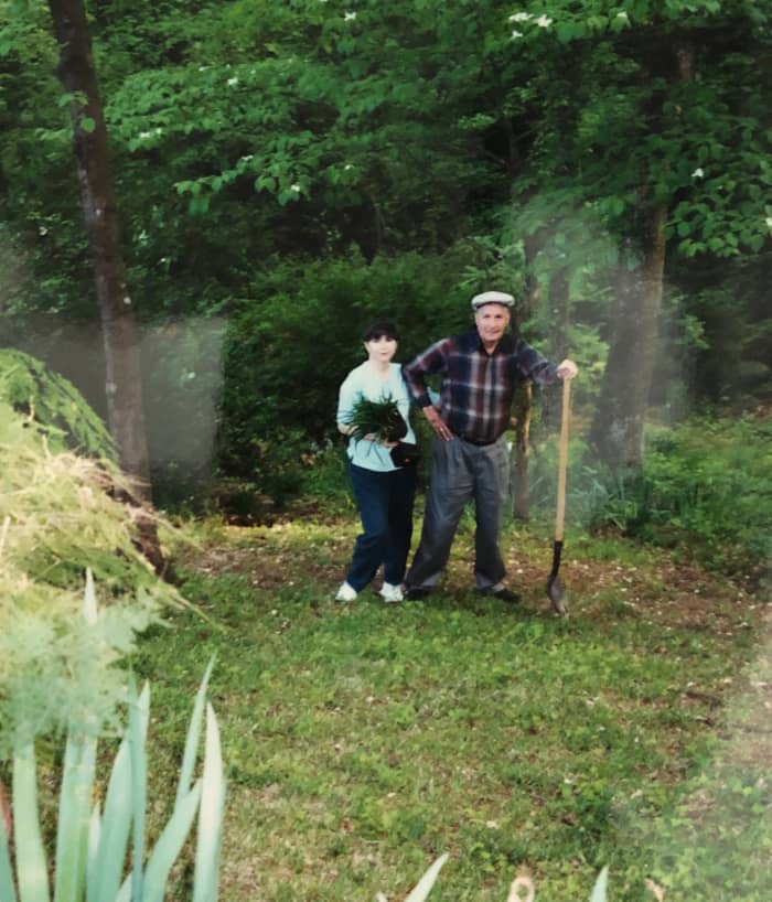 This is my dad and me. We had dug up some plants for me to put in my yard. By this time, he had grown too old to keep the entire hillside clear of underbrush, and I lived too far away (400 miles) to help.