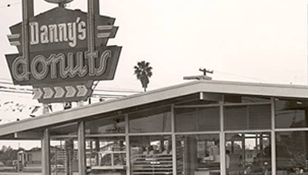 In 1953, the first Danny’s Donuts opened in Lakewood, California. Founded by Harold Butler and Richard Jezak, the name was eventually changed to Danny’s Coffee Shops, and then to Denny’s Restaurants in 1959.