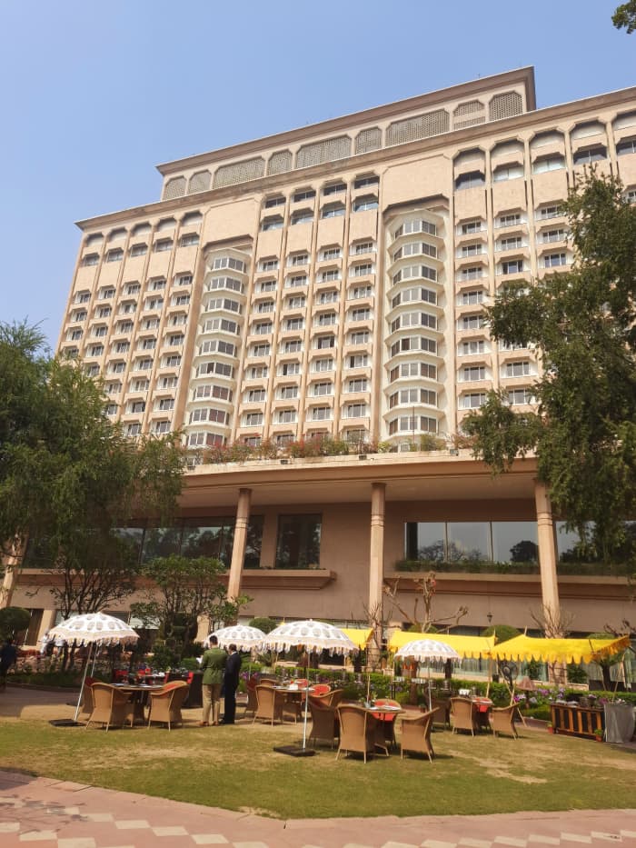 The back view of Taj hotel, Delhi, with the open air dining space, with greenery and flowers all around