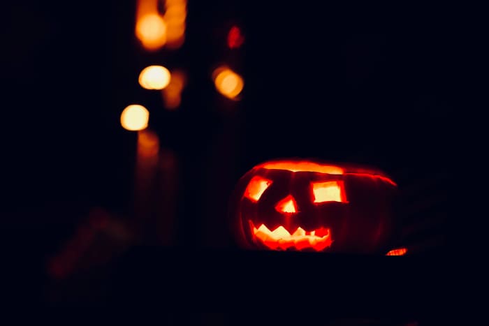 Creating a lid uses up a lot of precious pumpkin real estate! This carver would've had room for eyebrows and other flourishes if they had cut from the bottom instead.