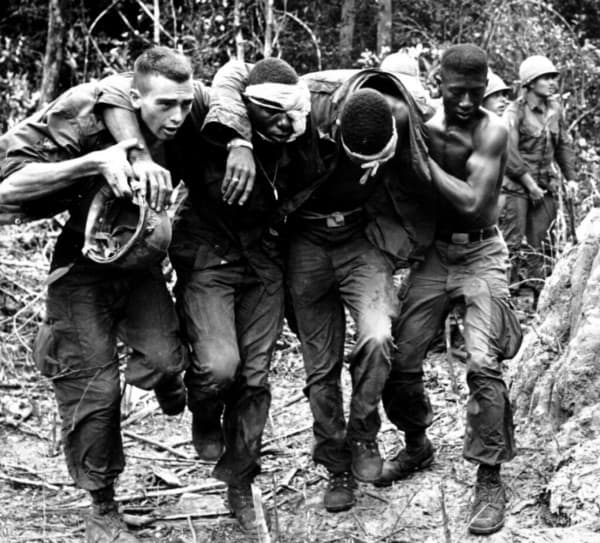 Life comes at you fast. Above: soldiers carrying each other during battle.