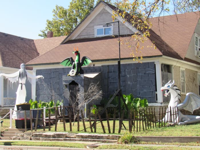 This front porch was converted into a spooky castle for Halloween and a fence was created to safely feature the inflatable characters.