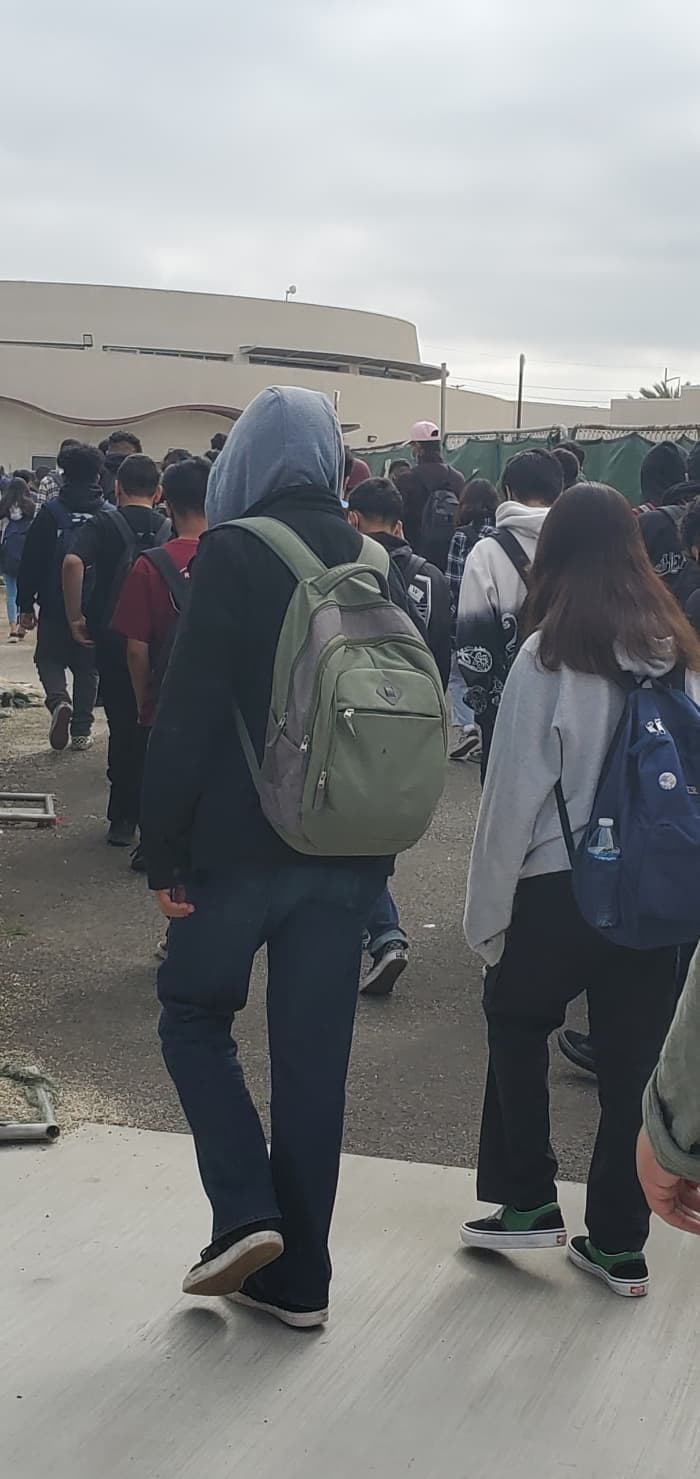 Students heading through narrow corridor that was created by ongoing construction on campus.