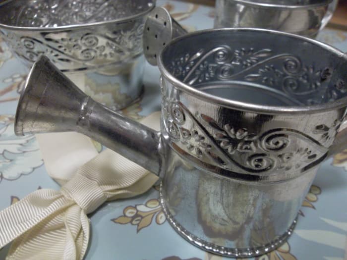 Supplies for wedding favors, including unique containers like this watering can, can be found at many arts and crafts stores.