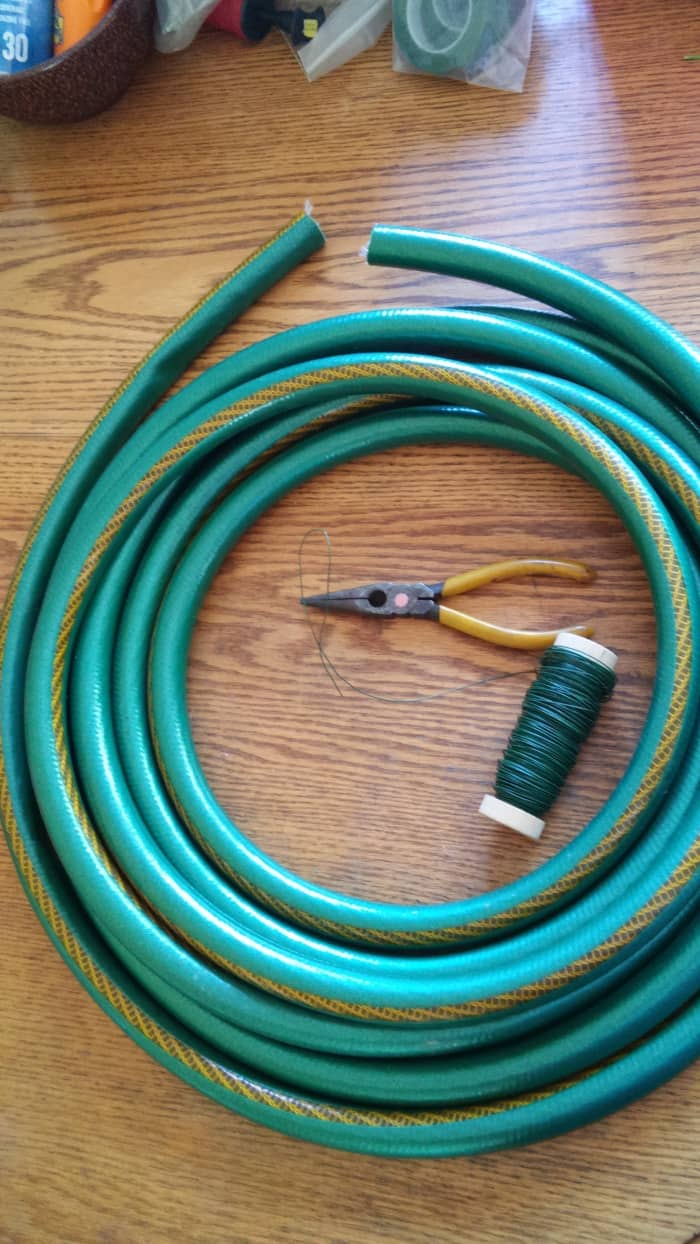 To assemble your wreath base you will need a hose, floral wire, needle-nose pliers with wire cutter, or separate pliers and wire cutters. As you can see I am using just a portion of a hose for this project.