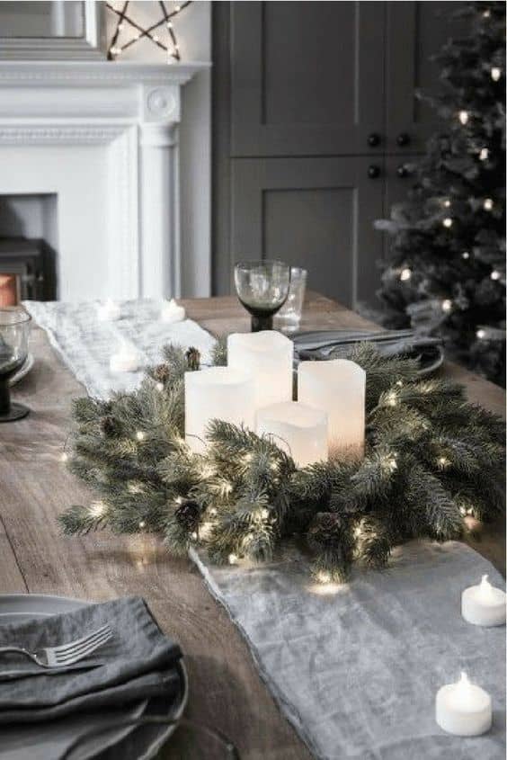For a clean and simple look, pair grey linens with an evergreen centerpiece, LED candles and tea lights.