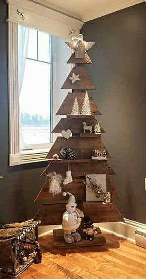This pallet tree was stained, and some small pieces of wood were added to form shelves. I love the all-white colour scheme against the darker brown background!