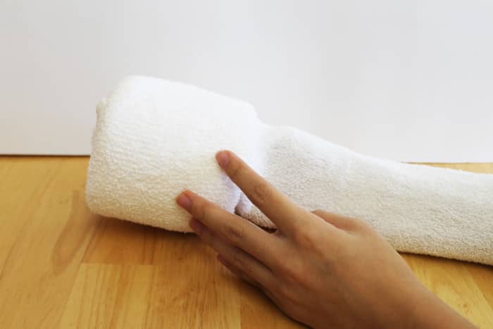 Work the toilet paper roll gently down until it is all the way to the end of the toe in the sock. Make sure the sock is pulled flat along the bottom of the roll so that the bottom surface will be flat and sit nicely on a surface.