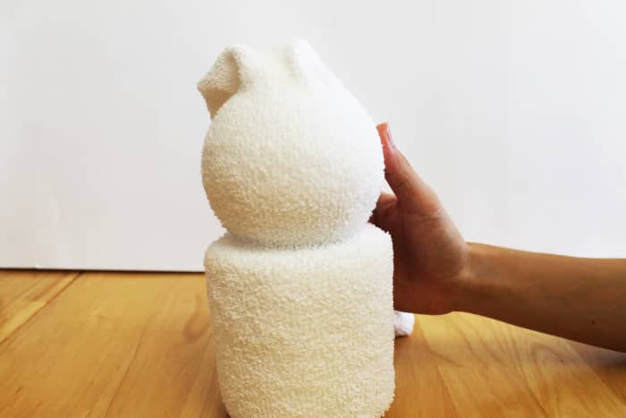 Note that we've left a little slack in the sock between the tp roll and the styrofoam ball to better define the neck area.