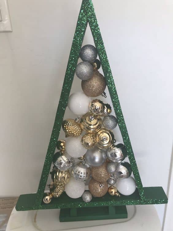 If you're using baubles in muted colors, you might give your tree form a bold paint job, like the glittery green here!