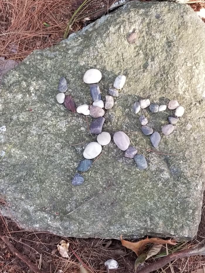 A couple of pictures made with pebbles by my co-housing neighbors at the center of the labyrinth among trees. Last summer a bunch of neighbors created a series of pix with pebbles for each other to enjoy.