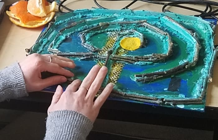 My friend Carey walks the labyrinth path I created for her. I needed to make sure the borders to the path were raised so that she could feel the path with her fingers.