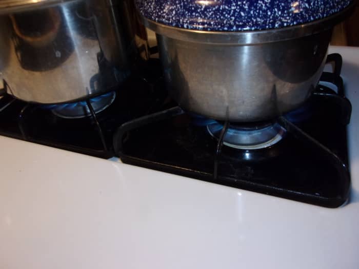After you've placed the noodles in the water, reduce the heat under both pots to medium just to allow it to simmer down a bit. You want a gentle simmer at this point, not a rolling boil.