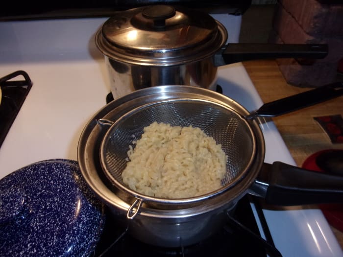 When your two minute timer goes off, strain the noodles and rinse them with hot water.