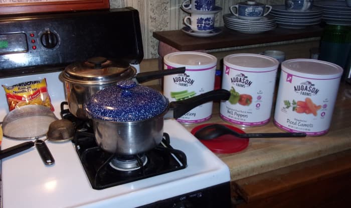 You'll need 2 pots with lids, 2 strainers, medium and small, a packet of ramen noodles and some dehydrated veggies.