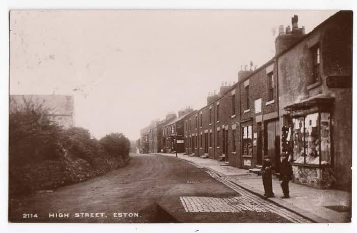 In Edwardian days the square would've been u nrecognisable. The view here is along the High Street eastward past the Eston Institute (left above the bushes and trees) and an array of shops on the right ...