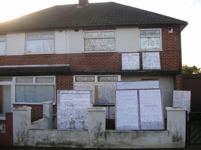 House decorated with bizarre writing. Inhabitant is presumed to suffer from schizophrenia.