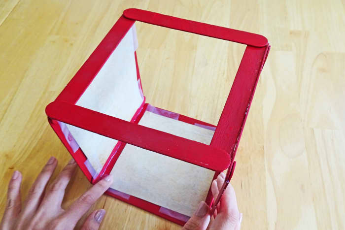 Tape or glue the picture to the insides of the squares. Make sure that all your images are facing the same way.