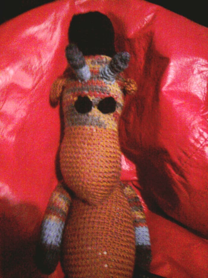Ugly Sweater Giraffe (my sister's fond name for the Christmas present I made her!) is chilling with his awesome top hat.