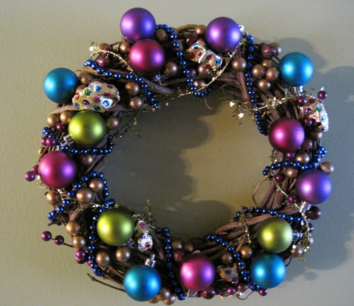 Clown Wreath - crafted with vine wreath, gold ball pics, polka-dot fabric, blue bead necklace, gold tinsel wire, and Christmas ornaments.
