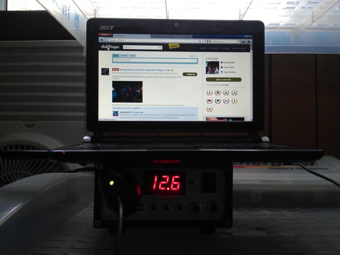 My netbook charging from the energy produced by the solar panels and stored in the 12 volt battery. Note the DC car charger connected to the controller.