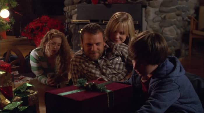 The Miller family (Magda Apanowicz, David Cubitt, Laura Harris and Dylan Matzke) celebrate Christmas Eve, which may be the last one