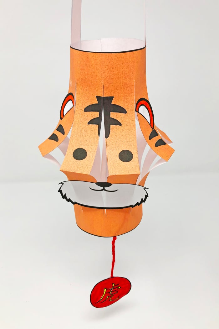 This template has two pages you can print. One has the orange base of the lantern, the other includes the handle, facial features and charm. You can find the documents link for this template below.