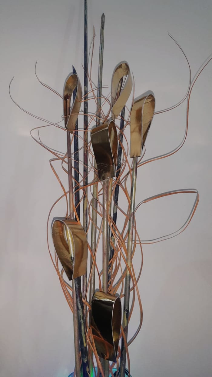 I folded them as in the photo and used hot glue to secure them on a stick made from paper quilling technique which I painted using acrylics to match my furniture. I used the orange swirls from an artificial plant.