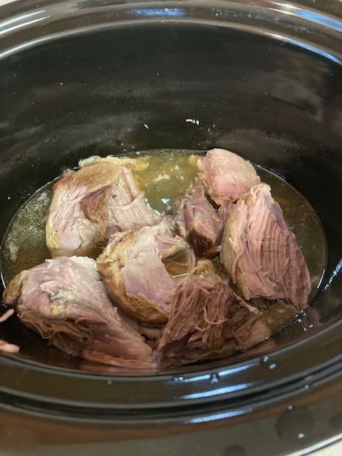 Crock-Pots vary in cooking speed. Follow the directions for cooking times for your pot, but the meat should separate with a fork when done. That's when it is time to add the sauerkraut.