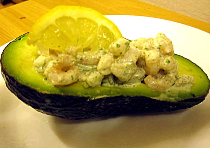 Shrimps coated with raw watercress dressing and loaded onto half an avocado make for a delicious and attractive starter.