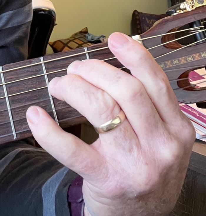 I can still make an E minor chord on my six string (2nd finger, 2nd fret of the A string; 3rd finger, 2nd fret of the D string)