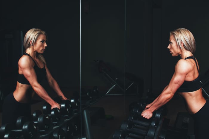 A human being lifting weights. The album's lyrical themes center around issues having to do with humans.