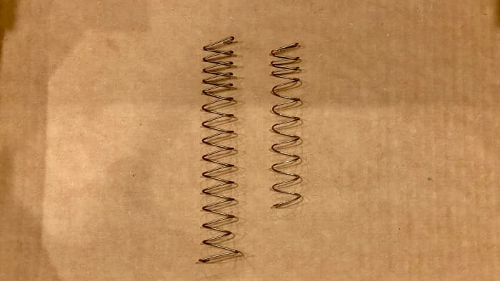 Springfield XDM compact magazine spring on the left compared to a Glock 21(full-size) spring on the right