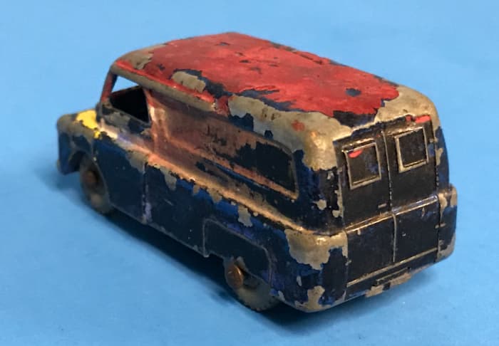 This poor van was covered in red, yellow and black paint. The original color was blue, as you can see below.
