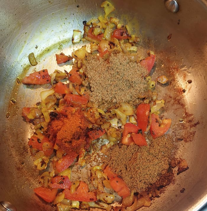 Add 1 teaspoon of red chili powder, 2 teaspoons of coriander powder and 1 teaspoon of cumin powder. Mix well over low flame. Do not burn the spices.
