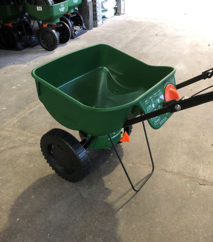 A broadcast spreader applies lawn fertilizer, fungicide and insecticide evenly as you push it across the turf.